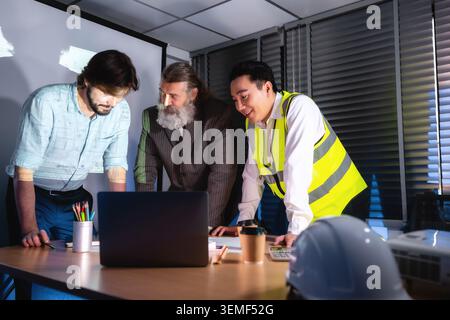 Engineer supervisor and Senior business professionals are discussing strategic building construction project planning, Three men discuss building plan Stock Photo