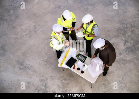 Real estate developers are evaluating construction sites to install solar power systems or utilize natural energy to future green building. High angle Stock Photo