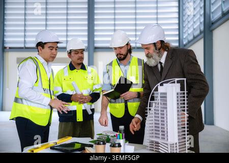Real estate developers are evaluating construction sites to install solar power systems or utilize natural energy to future green building. High angle Stock Photo