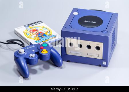 Fukuoka, Japan. June 6, 2026: Nintendo GameCube console with blue controller and Super Mario Sunshine game case photographed as a retro gaming product Stock Photo