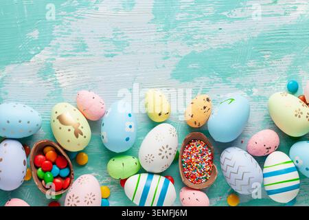 Colorful Easter Egg bottom border over a blue wooden background. Stock Photo