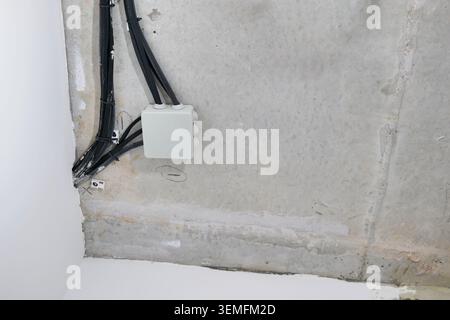 Electrical junction box and wires on concrete ceiling Stock Photo