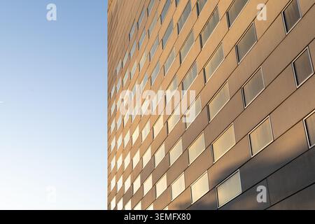 Wide horizontal view of MECA cultural center in Bordeaux, immersive geometric glass brick checkerboard facade dominating two thirds of frame against a Stock Photo