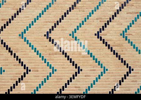 Decorative brickwork with turquoise and dark blue glazed tiles forming geometric patterns on Bibi Khanum Mosque in Samarkand. Tiles texture, pattern, Stock Photo