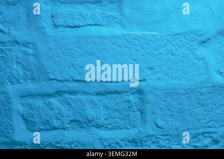 Turquoise blue painted brick wall texture close-up, traditional whitewashed building in Jodhpur, the Blue City of Rajasthan, India Stock Photo