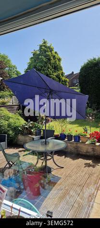 Outdoor Table and Umbrella on a Sunny Day Stock Photo