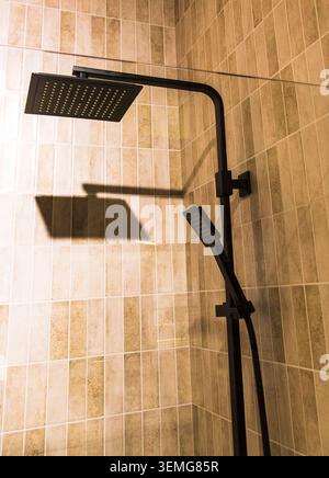 Modern Bathroom Shower Stall Setup with Textured Beige Vertical Tiles Stock Photo