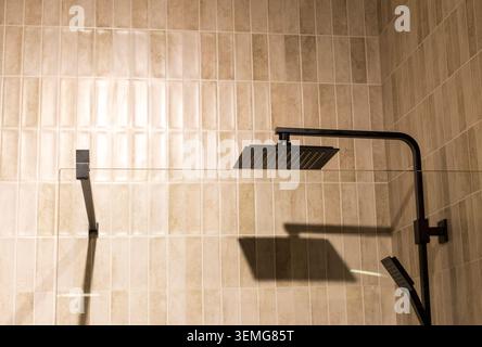 Modern Bathroom Shower Stall Setup with Textured Beige Vertical Tiles Stock Photo