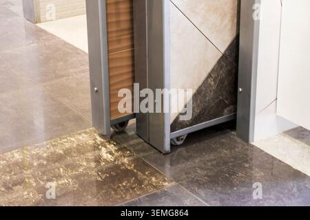 Sliding Ceramic Tile Display Rack on Wheels in Showroom Store Stock Photo