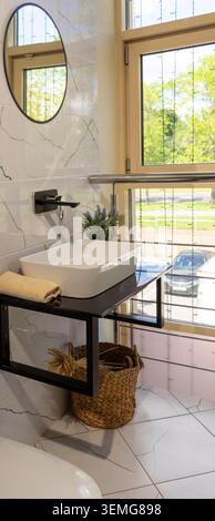 Modern Minimalist Bathroom with Vessel Sink and Marble Effect Tiles Stock Photo