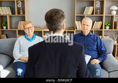 Senior couple in counseling with therapist during supportive mental health session Stock Photo