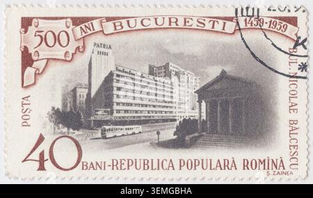 ROMANIA - 1959 September 20: 40 ban brown and gray postage stamp commemorates the 500th anniversary of Bucharest, celebrating five centuries of urban history. The modern cityscape of the capital city, focusing on the prominent Nicolae Bălcescu (Balcescu) Boulevard. On the left stands the iconic Patria Block, an emblem of modernist architecture featuring a cinema complex, with a classic trolleybus driving along the street below. To the right, the grand classical facade of the Romanian Athenaeum completes the view, bridging the historical and contemporary identity of the city Stock Photo