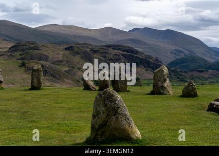 Close up details of ancient stones at Castlerigg Stone Circle, England. Fascinating mountain ranges in the background under a dark sky. No people Stock Photo