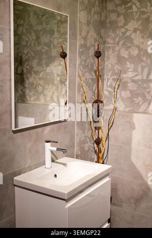 Modern Grey Bathroom Interior with Floating Vanity and Patterned Tiles Stock Photo
