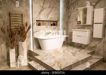 Luxury Bathroom Interior with Freestanding Bathtub and Gold Fixtures Stock Photo