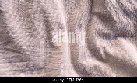 Textured background of rumpled gray cotton cloth with deep wrinkles and shadows Stock Photo