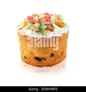 Traditional Easter cake topped with white icing candied fruit raisins and colorful sprinkles isolated on white background with reflection. Stock Photo