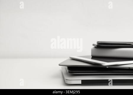 Stack of different modern gadgets on light background Stock Photo
