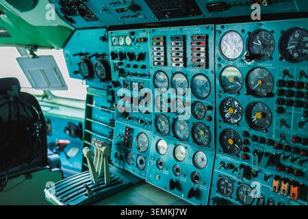 Inside an aircraft cockpit, the control panel displays multiple dials and switches used for monitoring and controlling flight operations. The equipmen Stock Photo