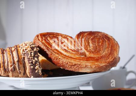 Bakery and pastry shop, culinary art and tradition of Mexico, Assorted sweet bread on a white plate in the kitchen, side view, with OREJA and Vanilla Stock Photo