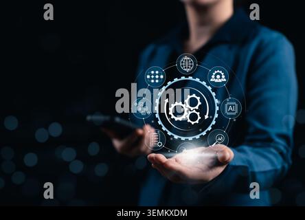 Business Process Automation and Workflow Optimization System Concept. Businessman holds gears, workflow icons, data network, checklist, analytics, Stock Photo