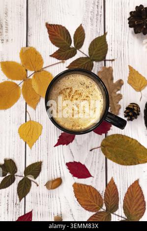Festive Halloween autumn background. Autumn decor of pumpkins, berries, maple leaves and chestnuts on old rustic white wooden surfaces. Concept of Hal Stock Photo