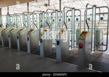 Railway station ticket gates row made of stainless steel at transit terminal entrance, modern automatic passenger turnstiles with electronic card read Stock Photo