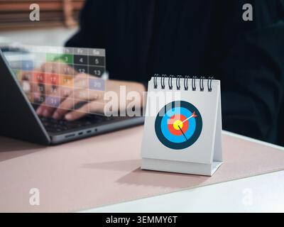 Business goal planning concept with target icon on desk calendar schedule. strategic planning, timeline management, productivity improvement, deadline Stock Photo