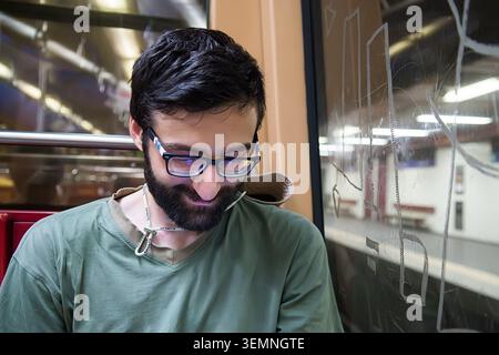 Young pretty hipster guy traveler in subway Stock Photo