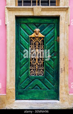 Old wooden door with vintage metal frame pattern Stock Photo