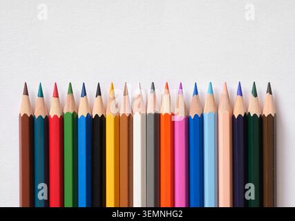 Row of sharpened colored pencils forming a rainbow spectrum, illustrating creativity, school, art, and education concepts Stock Photo