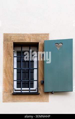 Plastic window with lattice and open shutter Stock Photo