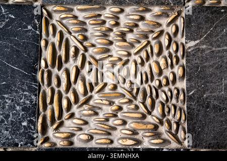 Patterned pavement in the park. Traditional pebble mosaic sidewalk Stock Photo
