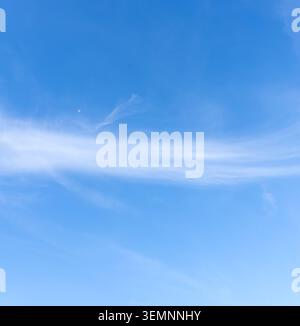 Low angle view and full frame of beautiful light blue sky with strange shape of fluffy thin white clouds in the afternoon on sunny day Stock Photo