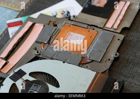 Close-up of laptop cooling system with copper heatsink, thermal pads and fan, symbolizing computer hardware, electronics and thermal management design Stock Photo