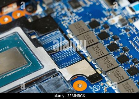 Close-up of electronic circuit board with integrated circuits, capacitors and connectors, symbolizing modern computer hardware and complex electronics Stock Photo