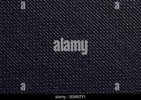 Macro shot of dark ribbed fabric texture with diagonal lines. Close up background of black textured material with geometric diagonal pattern Stock Photo
