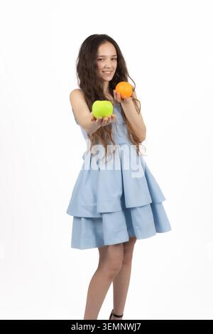 Healthy young woman holding two fresh green apples near her face Stock Photo