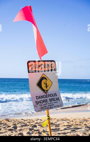 Warning sign for dangerous shore break at a beach in Hawaii Stock Photo