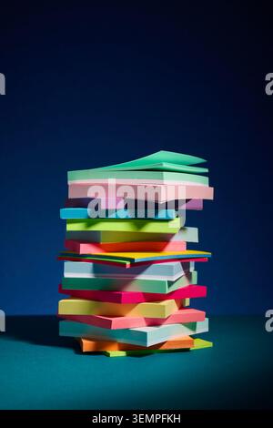 Tall jumbled stack of colorful sticky notes Stock Photo