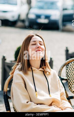 Young woman enjoying the sunshine in urban style Stock Photo