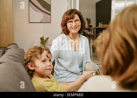 Middle Aged Woman Spending Time with Family at Home Stock Photo