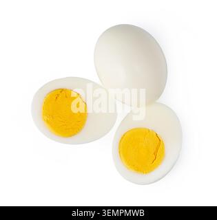 Hard-boiled chicken eggs showing one whole and two halves with visible yolk and white Stock Photo