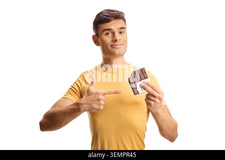 Young man pointing at a bitten chocolate bar isolated on white background Stock Photo