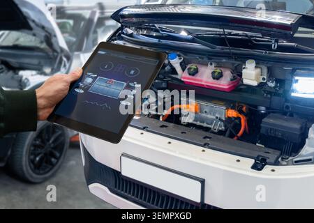 Checking the battery pack of an electric car at a service center. Stock Photo