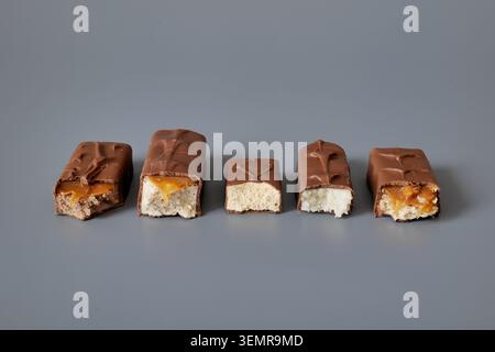 Five chocolate bars with assorted fillings on a gray background Stock Photo