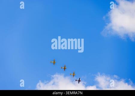 Propeller planes flying in formation on a blue sky Stock Photo