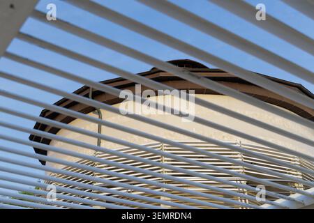 Architectural play of light and lines. The white circular lighthouse building. Stock Photo