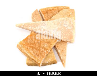 Large thick rinds of aged cheese on white background. Stock Photo