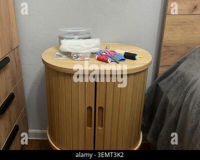 A tailor's sewing kit on a table. Needles, thread, and fabric for sewing. Stock Photo
